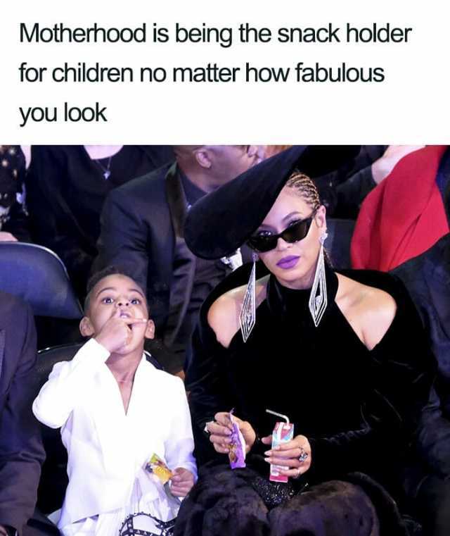 Motherhood is being the snack holder for children no matter how fabulous you look